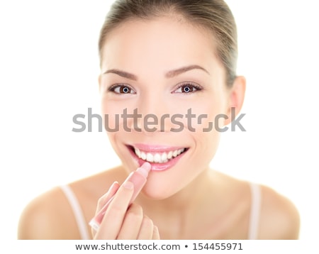Zdjęcia stock: Pretty Young Woman Applying Lip Gloss On White Background