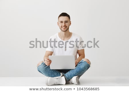 Foto stock: Male Model Sitting With Legs Crossed