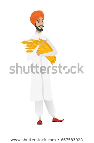 Foto stock: Young Hindu Farmer Holding Hay In Hands