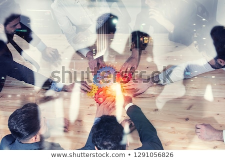 Foto stock: Business Team Connect Pieces Of Gears Teamwork Partnership And Integration Concept Double Exposur