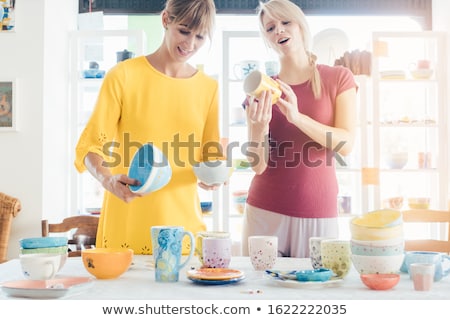 Сток-фото: Women Buying Ceramic Dishes In A Workshop