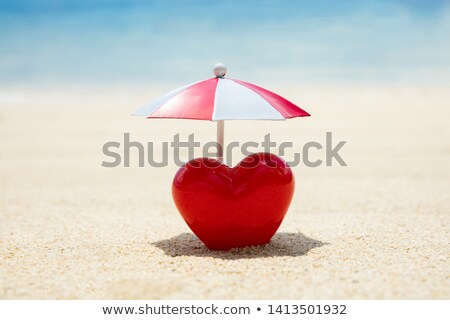 Stok fotoğraf: Red Painted Heart Under The Umbrella On Sand