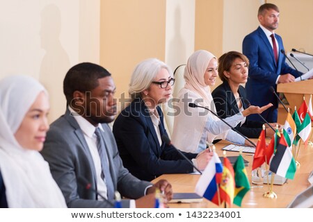 Stok fotoğraf: One Of Muslim Women In Traditional Hijab Explaining Her Point Of View