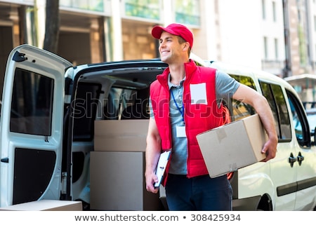 Сток-фото: Courier Delivery Man Checking Or Holding Cardboard Parcel Packag