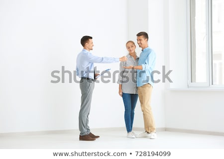 Foto stock: Realtor In Empty Apartment Giving Keys