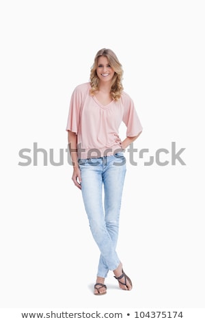 Foto stock: Woman Standing With Her Legs Crossed On Studio Background