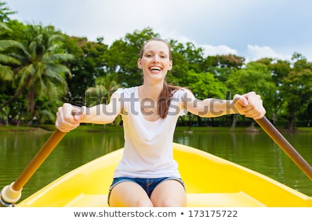 Foto stock: People Rowing In Boats On Lake Enjoying Summer