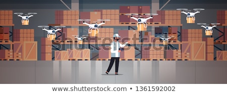 Stock photo: Man Controlling Delivery Drone With Post Package