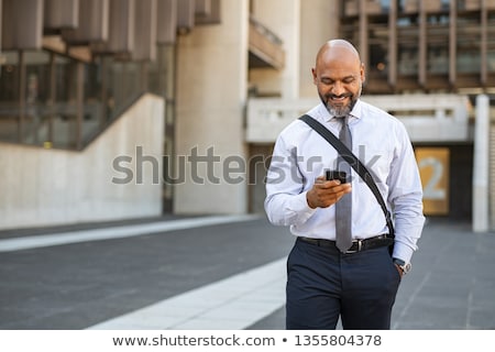 Stok fotoğraf: Mature Man Standing In Street On Phone