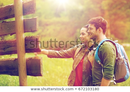 Сток-фото: Couple Of Travelers With Backpacks At Signpost
