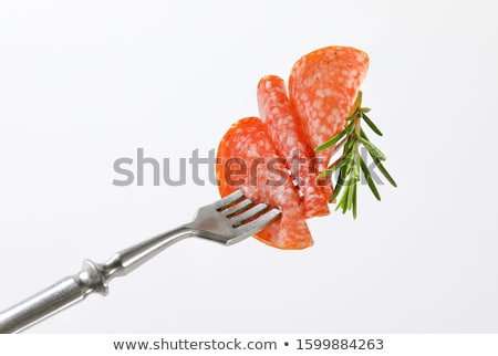 Zdjęcia stock: Thin Salami Slice And Rosemary On Fork