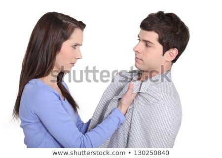 Stok fotoğraf: Young Woman Grabbing A Man By His Lapels