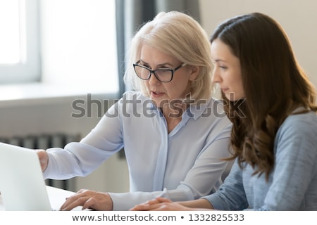 Foto stock: Young Female Apprentice And Mature Mentor