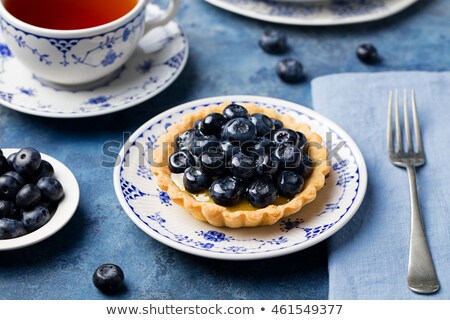 [[stock_photo]]: Blueberry Tartlet Pie Tart With Vanilla Custard Blue Stone Background