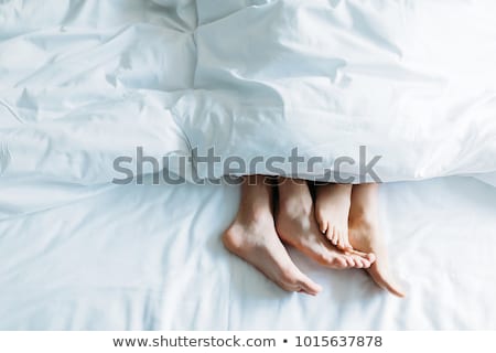 Stock photo: Couples Feet On Bed
