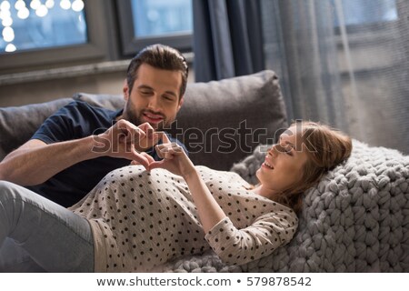 Foto stock: Happy Pregnant Woman Showing Heart Gesture