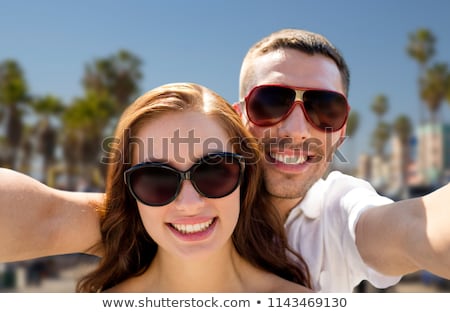 Foto d'archivio: Couple In Shades Making Selfie Over Venice Beach