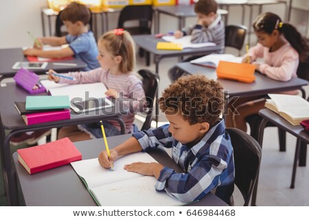 [[stock_photo]]: Schoolboy Studying On Digital Tablet In Classroom Of Elementary School