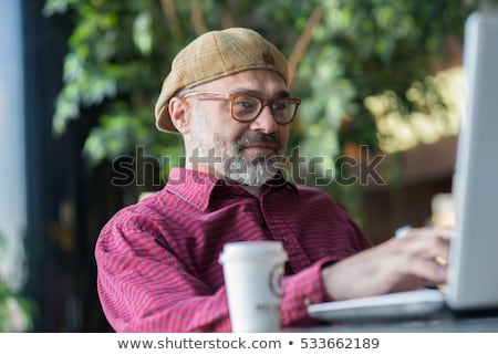 Stock photo: Portrait Of An Older Businessman With A Computer And A Cup