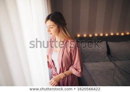 [[stock_photo]]: Blond Woman Looking Through Bracelet