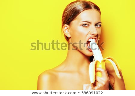 Foto d'archivio: Portrait Of Funny Beautiful Young Woman Eating Banana