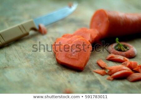 Stockfoto: Chopped Carrots In The Shape Of A Heart With Knife