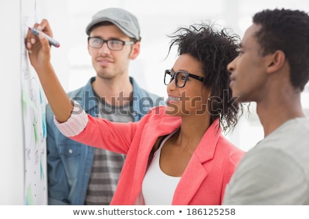 Foto stock: Artists In Discussion In Front Of Whiteboard