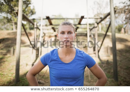 ストックフォト: Tired Woman Standing With Hand On Hip In The Boot Camp