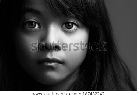 Foto stock: Close Up Portrait Of A Pensive Young Asian Girl