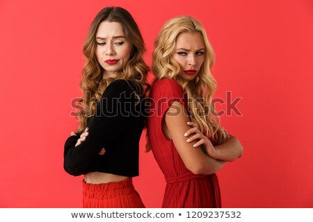 Foto stock: Displeased Quarrel Young Friends Women Standing Isolated Over Red Background