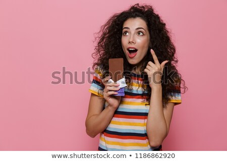 ストックフォト: Photo Of Pretty Woman 20s With Curly Hair Holding Chocolate Bar