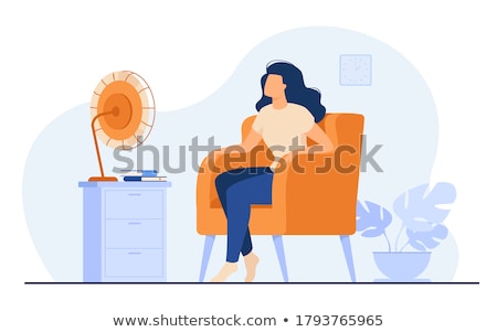 Zdjęcia stock: Woman Enjoying Breeze With Electric Fan