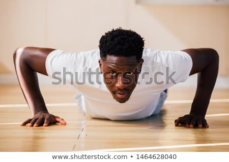 Stockfoto: Adult Man Training Chest Muscles At Home Doing Push Ups