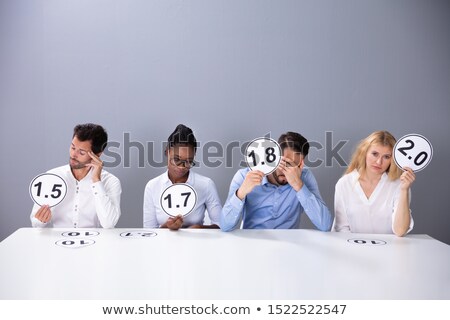 [[stock_photo]]: Sad Business People Showing Low Score Cards