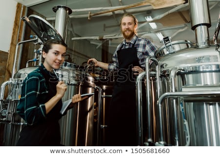 Foto stock: Man With Clipboard At Craft Brewery Or Beer Plant