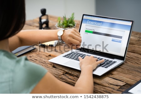 Stockfoto: Stressed Woman Looking At Slow Download Speed