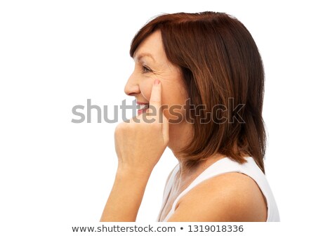 [[stock_photo]]: Profile Of Senior Woman Pointing To Eye Wrinkles