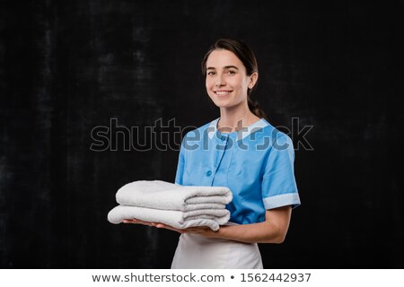 Foto stock: Pretty Young Chamber Maid In Uniform Holding Two Folded White Soft Towels