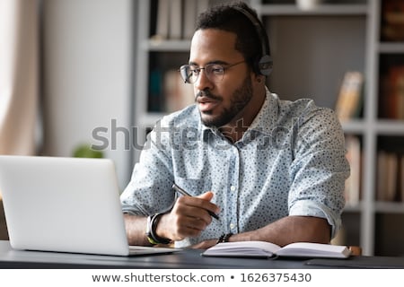 Stock photo: Image Of African American Man In Headphones Using Laptop Compute