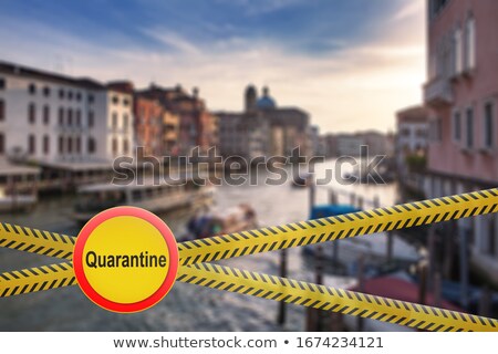 Foto stock: Warning Sign Of Quarantine On Crossing Police Lines On A Blurred Background Of Grand Canal In Venice