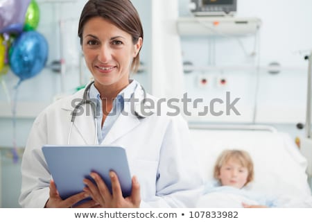 Stock photo: Female Doctor Touching A Tablet Computer In Hospital Ward