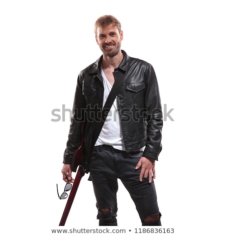 [[stock_photo]]: Portrait Of Joyful Young Guitarist Holding His Sunglasses