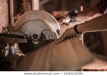 Сток-фото: Carpenters Working With Saw And Wood At Workshop