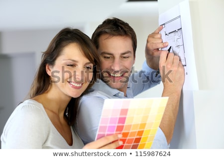 ストックフォト: Happy Couple With Color Samples At New Home