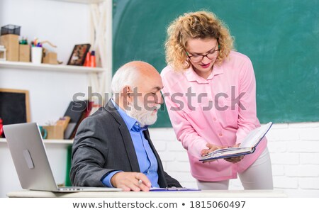 Stock fotó: Teacher Helping Student With Difficult Task In School