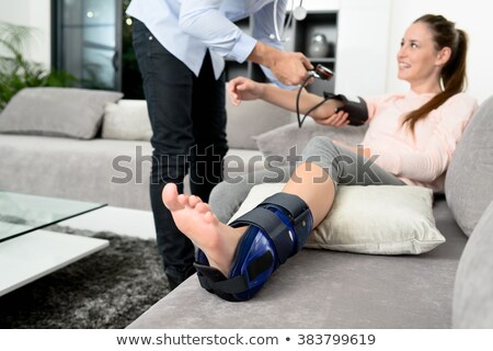 Foto stock: Young Handsome Doctor Visiting Female Patient At Home