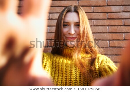 [[stock_photo]]: Young Redhead Woman Covering Camera Lens With Hands