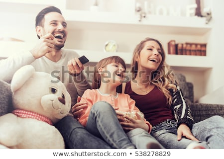 ストックフォト: Young Man Watching Tv And Eating Popcorn