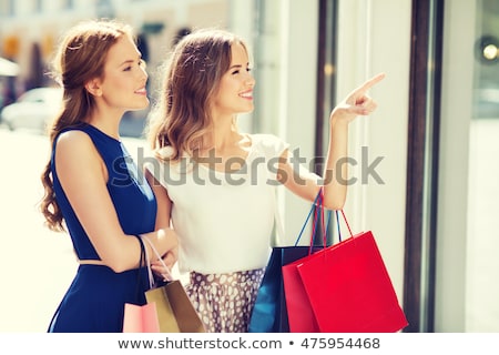 Stok fotoğraf: Two Pretty Young Women Window Shopping In A City