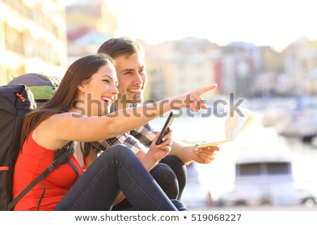 Foto stock: Girl Looking For Place On Map With Rucksack